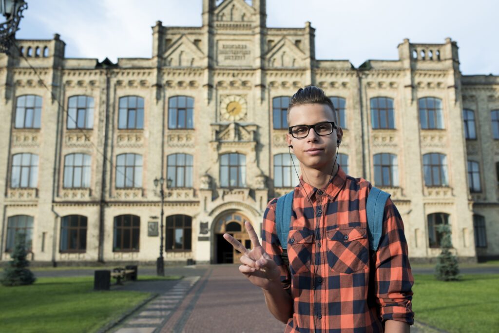 medium-shot-teenage-boy-showing-peace-sign